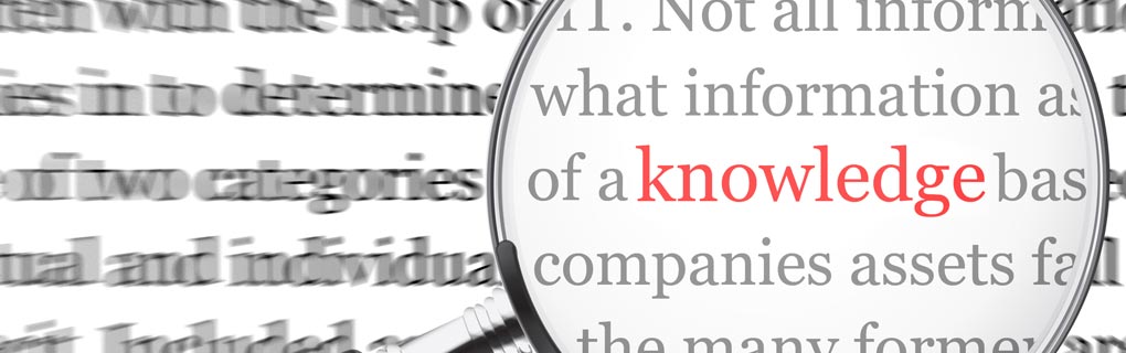 Magnifying glass focusing on the word knowledge